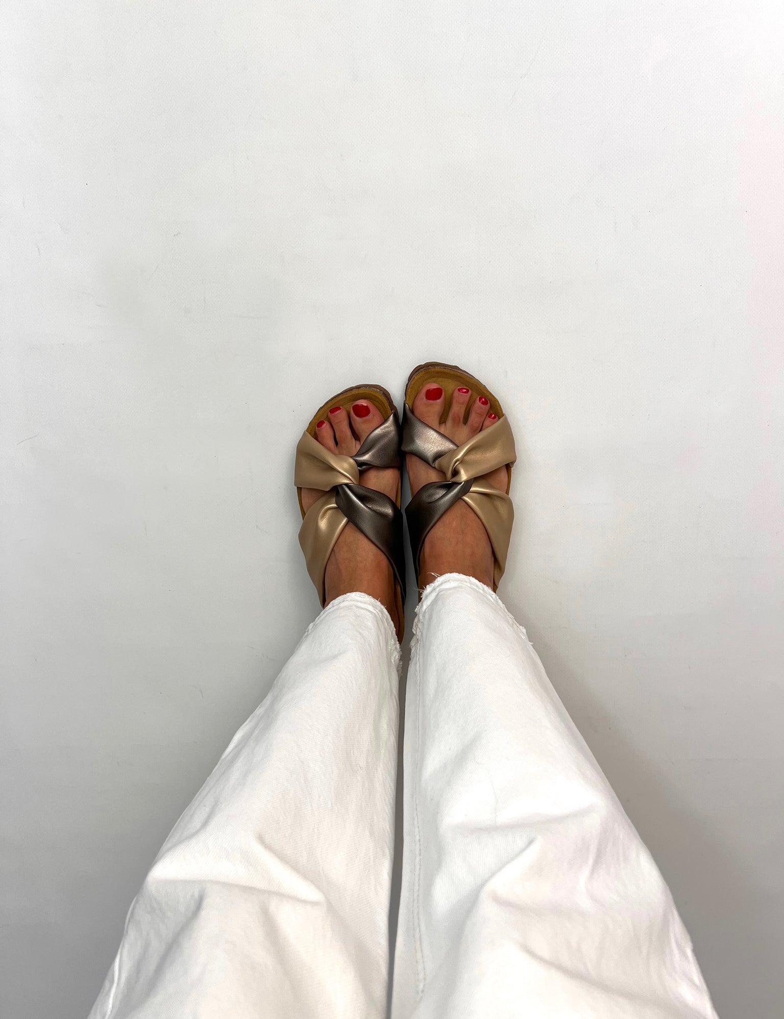 Momoc Calpe bronze champagne knotted sandals worn front view white trousers cork sole sustainable Spain | Momoc Shoes Spain