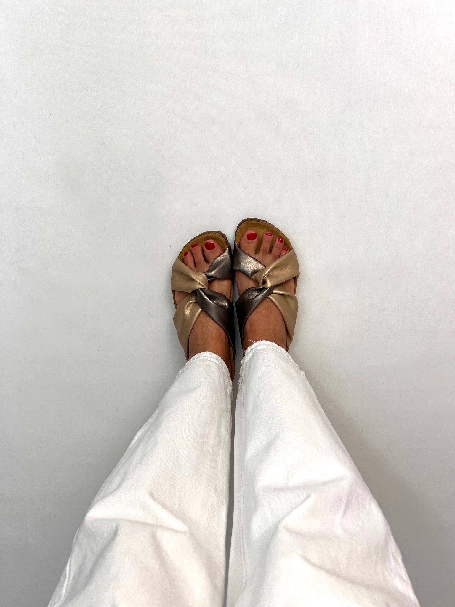 Momoc Calpe bronze champagne knotted sandals worn front view white trousers cork sole sustainable Spain | Momoc Shoes Spain