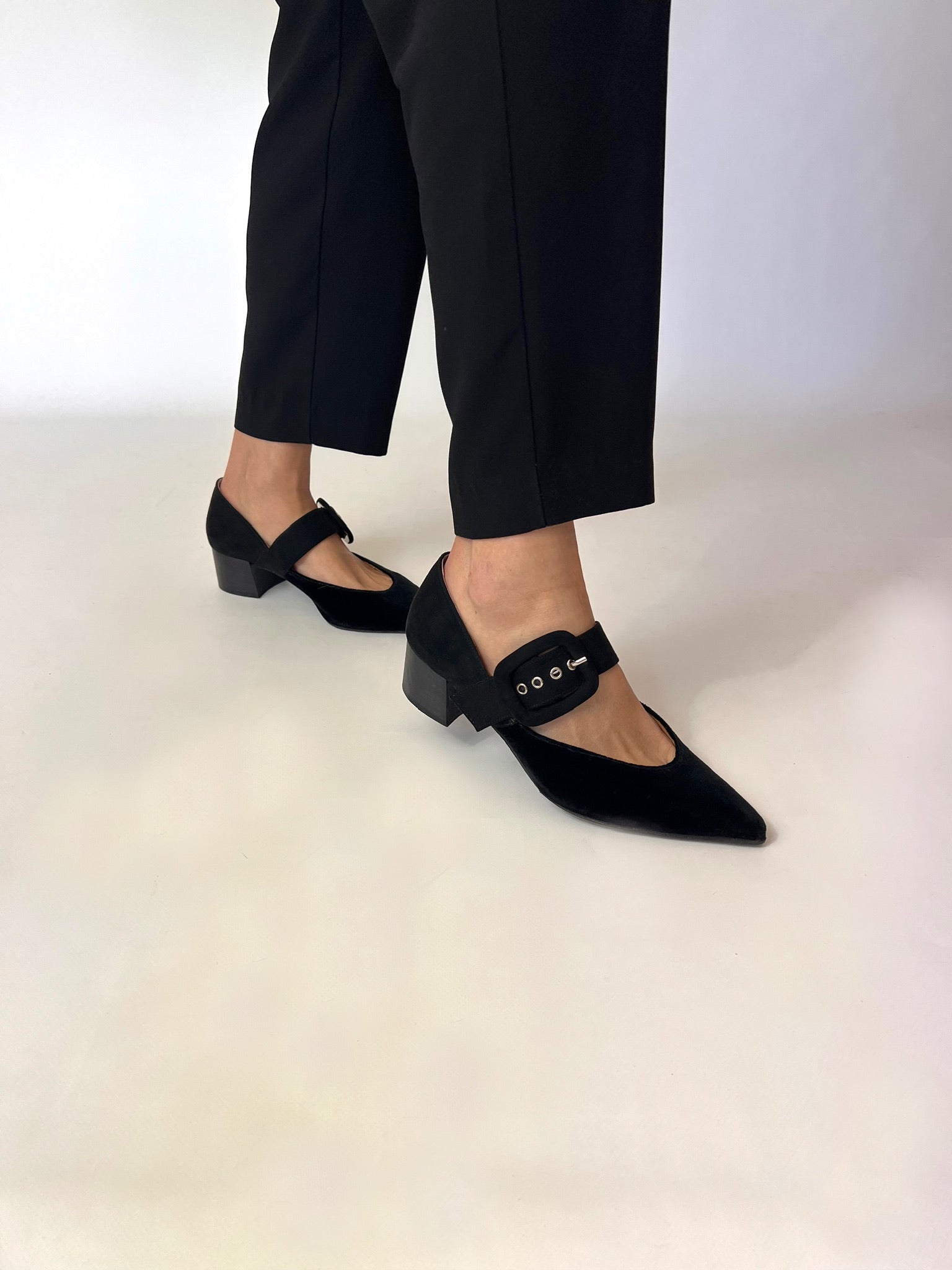 Momoc Sorbonne black velvet midi heel side view walking black trousers white background | Momoc Shoes