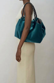 Momoc Lucrecia teal velvet bag black braided handle held by shoulder beige outfit | Momoc Shoes