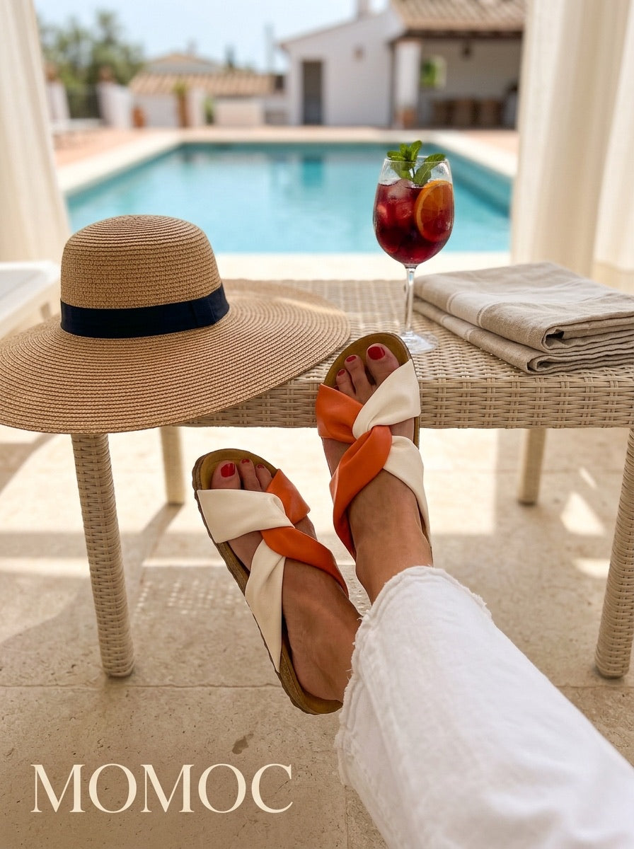 Momoc Calpe orange cream knotted sandals worn top view white jeans both feet vegan Spain swimming pool at the background and drink | Momoc Shoes Spain