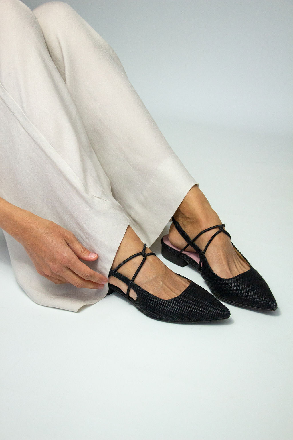 Momoc Menorca black backless sandals worn side view white trousers | Momoc Shoes Spain