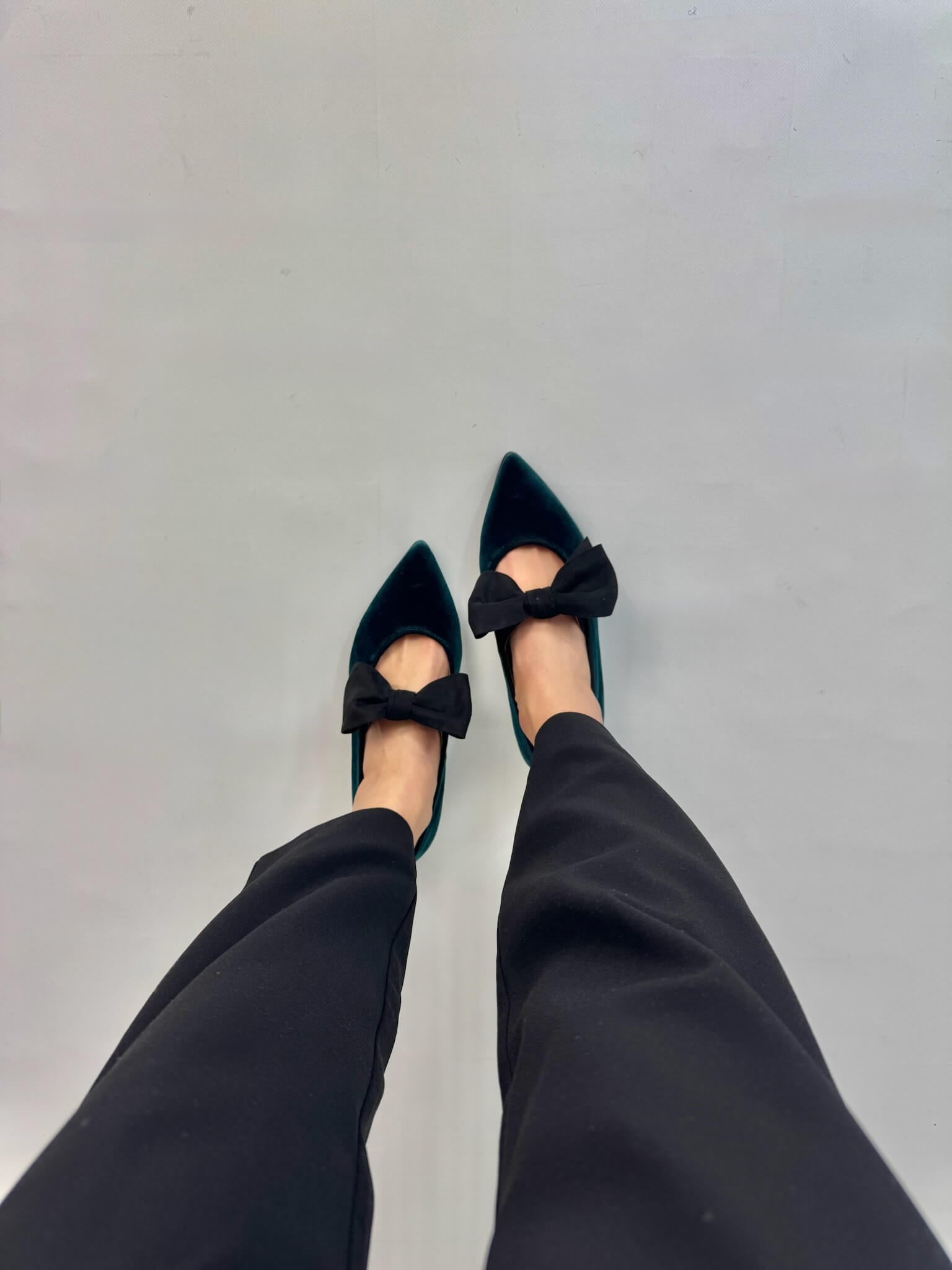 Momoc green velvet ballet flats worn top view dark trousers black bow detail | Momoc Shoes