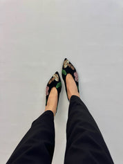 Multicolor embroidered ballet flats worn top view feet dark trousers | Momoc Shoes Spain