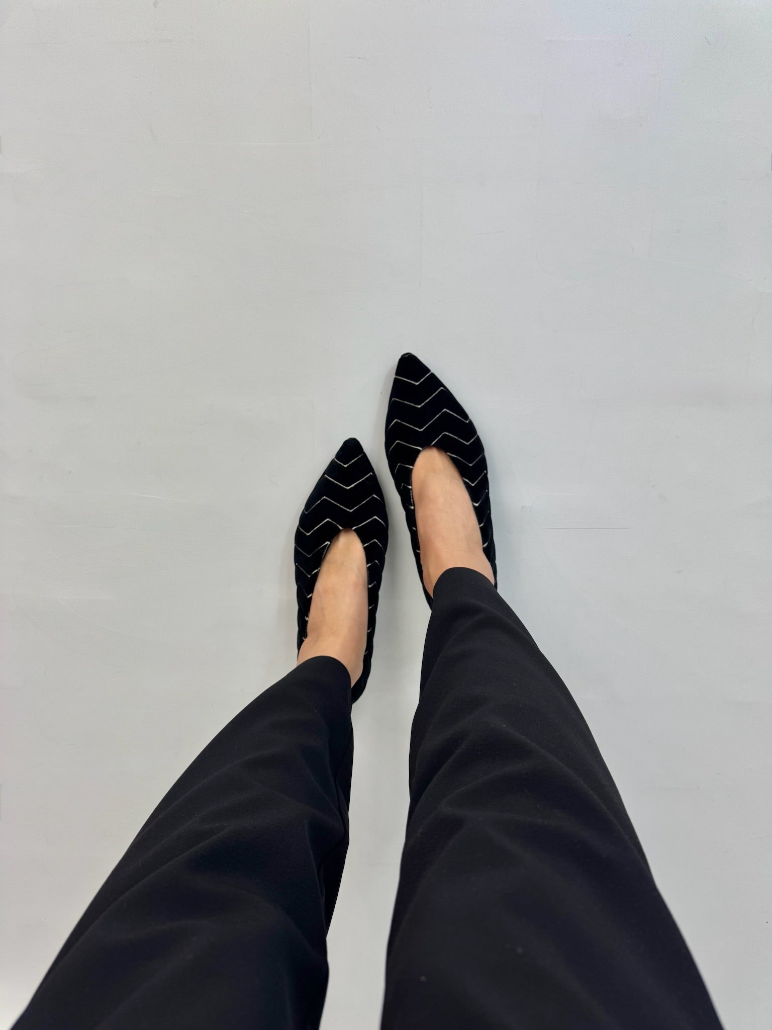 Black velvet ballet flats worn side view dark trousers | Momoc Shoes Spain