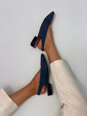 Momoc Luna backless sandals pair top view petrol blue red toe pink insole with little heels with beige trousers and white background | Momoc Shoes Spain