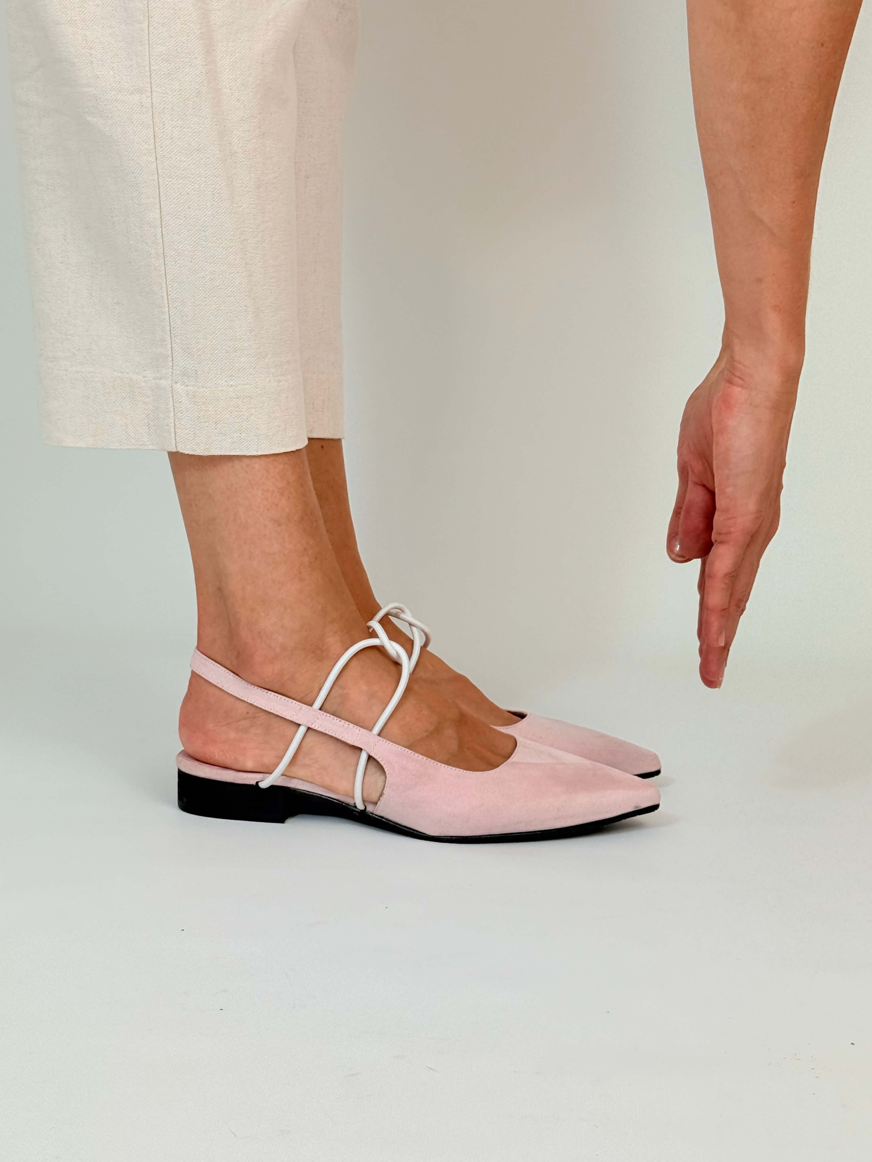 Momoc Menorca pink slingback sandals worn lifestyle model hand touching foot elegant summer | Momoc Shoes