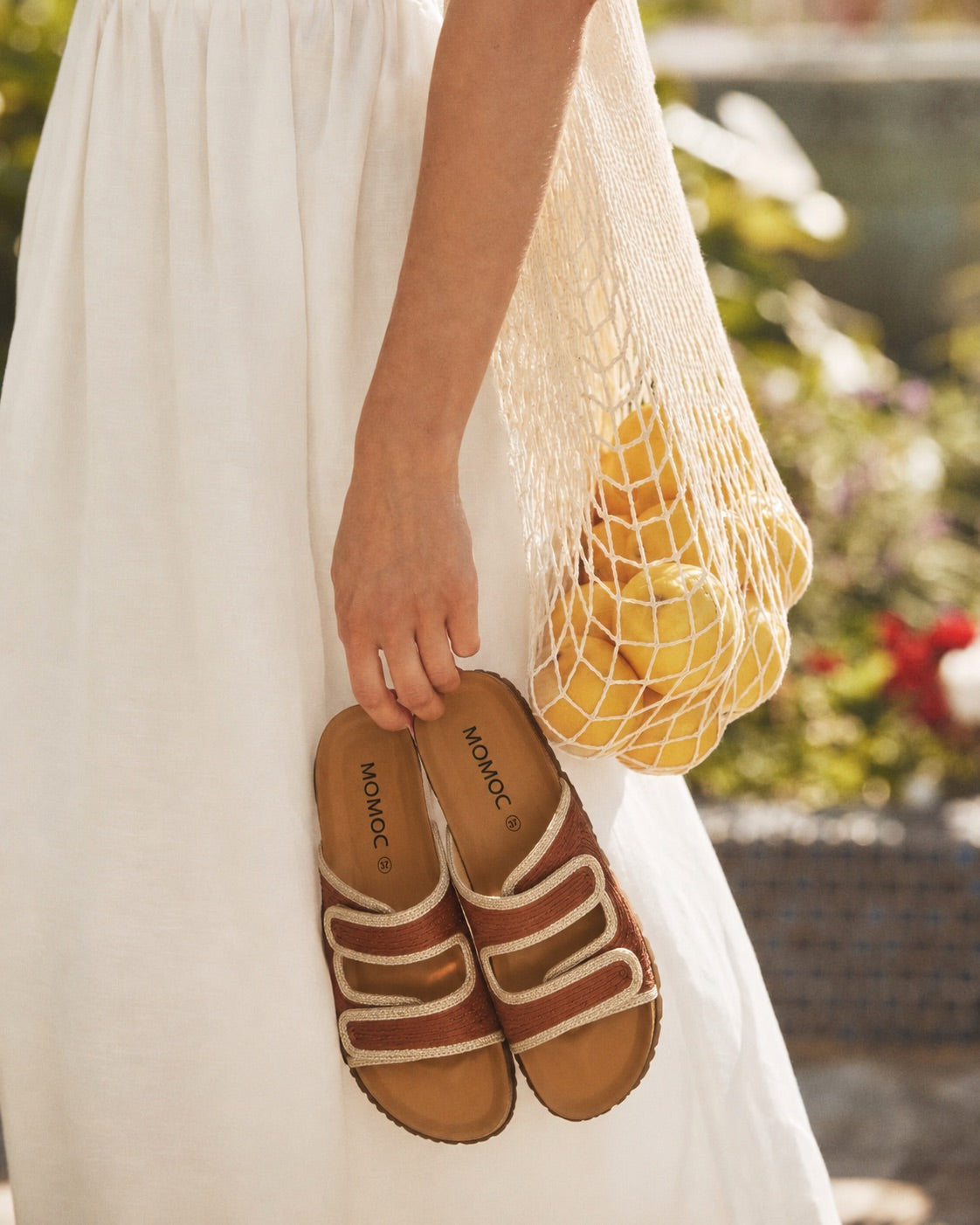 Momoc Biar terracotta sandals worn model white dress lifestyle summer holding market bag Spain | Momoc Shoes Spain
