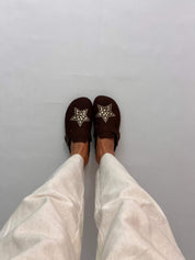 Momoc A Star Chocolate clogs worn top view white trousers gold star studs vegan Spain | Momoc Shoes Spain