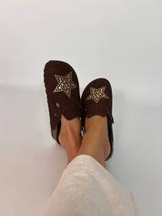 Momoc A Star Chocolate clogs worn side view white linen trousers gold metallic stars | Momoc Shoes Spain