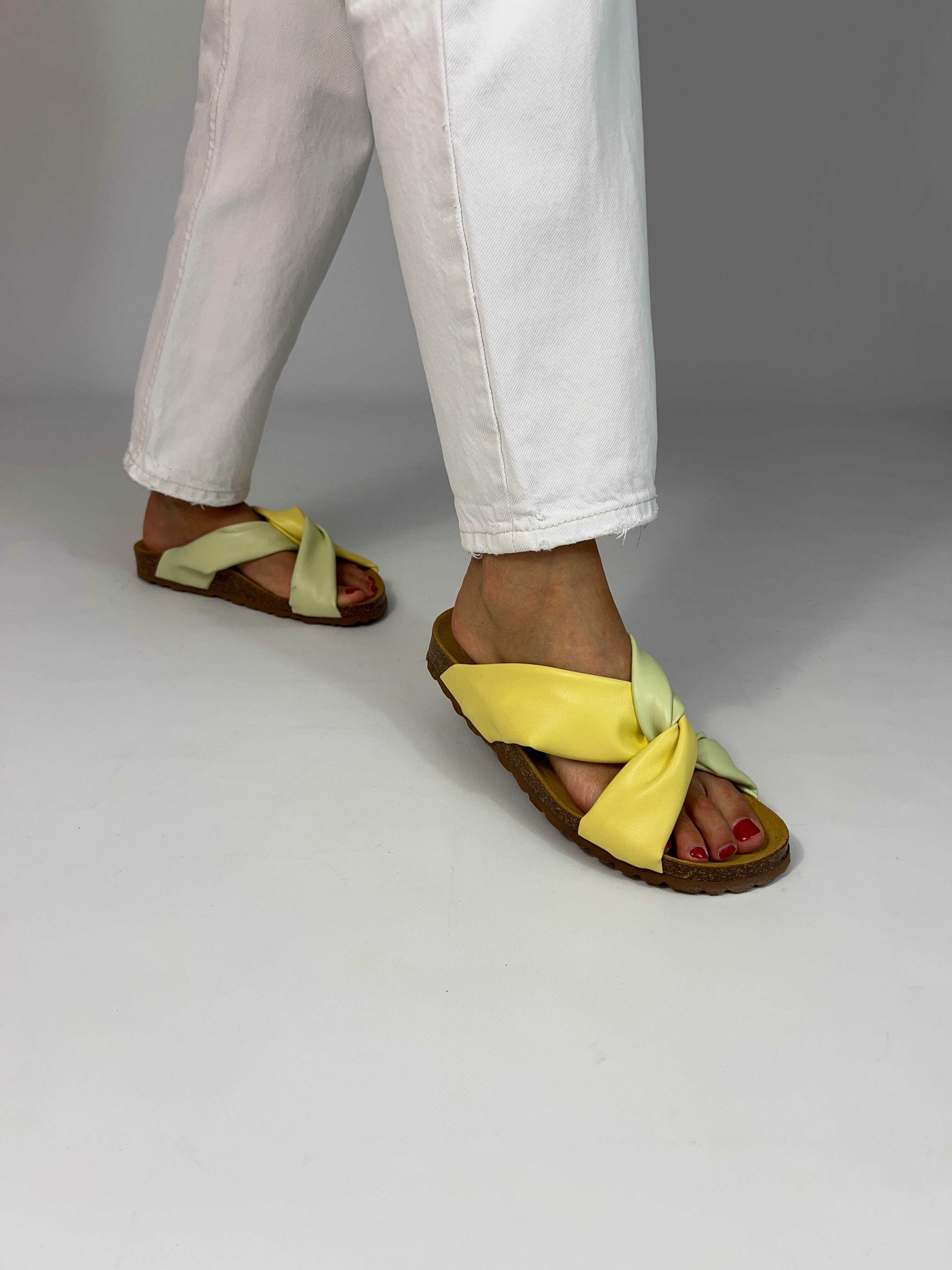 Momoc Calpe butter yellow green sandals worn front view white trousers central knot detail handmade | Momoc Shoes