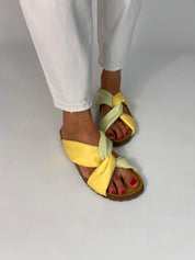 Momoc Calpe butter yellow pistachio sandals worn top view white jeans both feet vegan Spain | Momoc Shoes