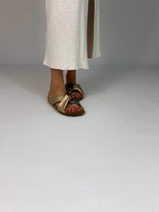 Momoc Calpe bronze champagne knotted sandals worn side view white skirt both feet vegan Spain | Momoc Shoes Spain