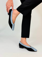 Momoc Coral Reef Blue black cotton velvet ballet flats worn hands adjusting fit black trousers Spain | Momoc Shoes Spain