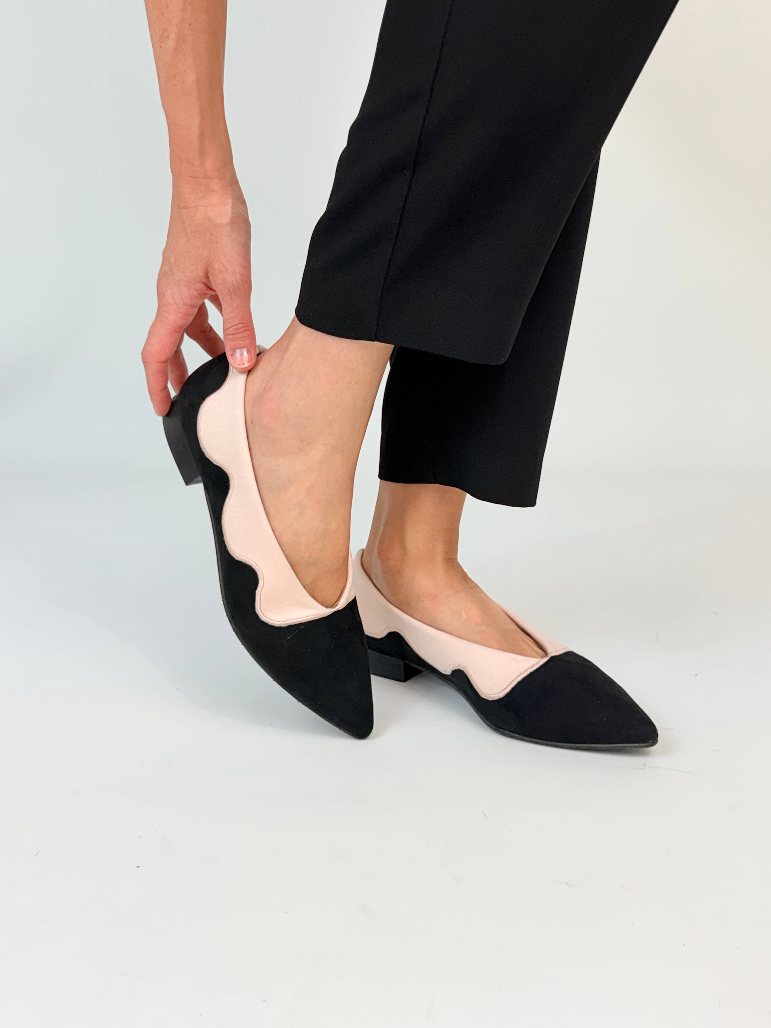 Momoc Sea Breeze black cotton velvet ballet flats worn hands adjusting fit black trousers elegant Spain | Momoc Shoes