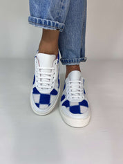 Momoc Patchwork sneakers worn side view light denim jeans crossed leg lifestyle vegan Spain | Momoc Shoes Spain