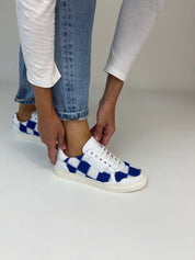 Momoc Patchwork sneakers worn crossed feet light denim jeans front view artisan handmade Spain | Momoc Shoes Spain
