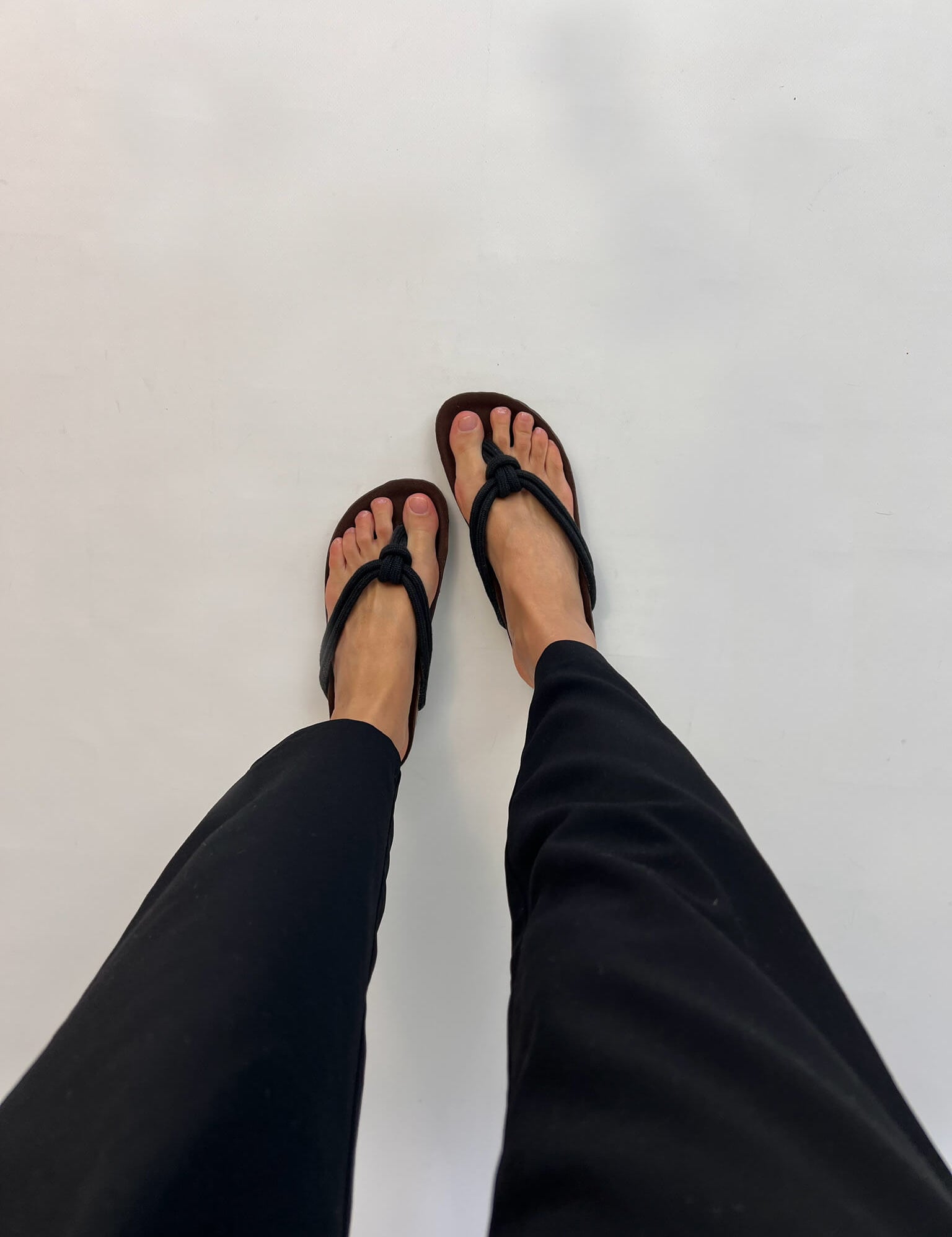 Momoc Javea black rope sandal worn top view black trousers cork sole sustainable Spain | Momoc Shoes Spain
