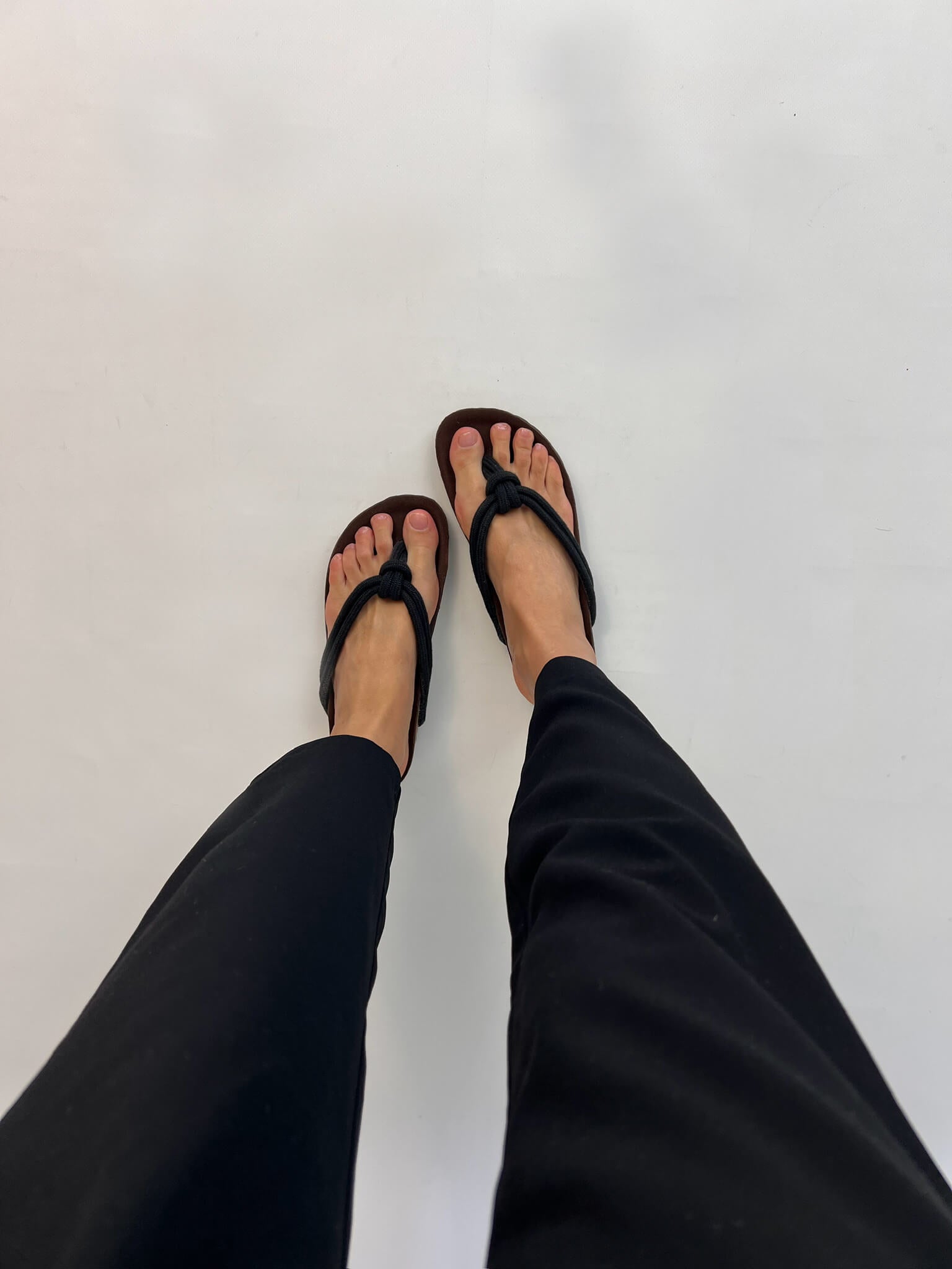 Momoc Javea black rope sandal worn top view black trousers cork sole sustainable Spain | Momoc Shoes Spain