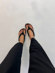 Momoc Javea black rope sandal worn top view black trousers cork sole sustainable Spain | Momoc Shoes Spain