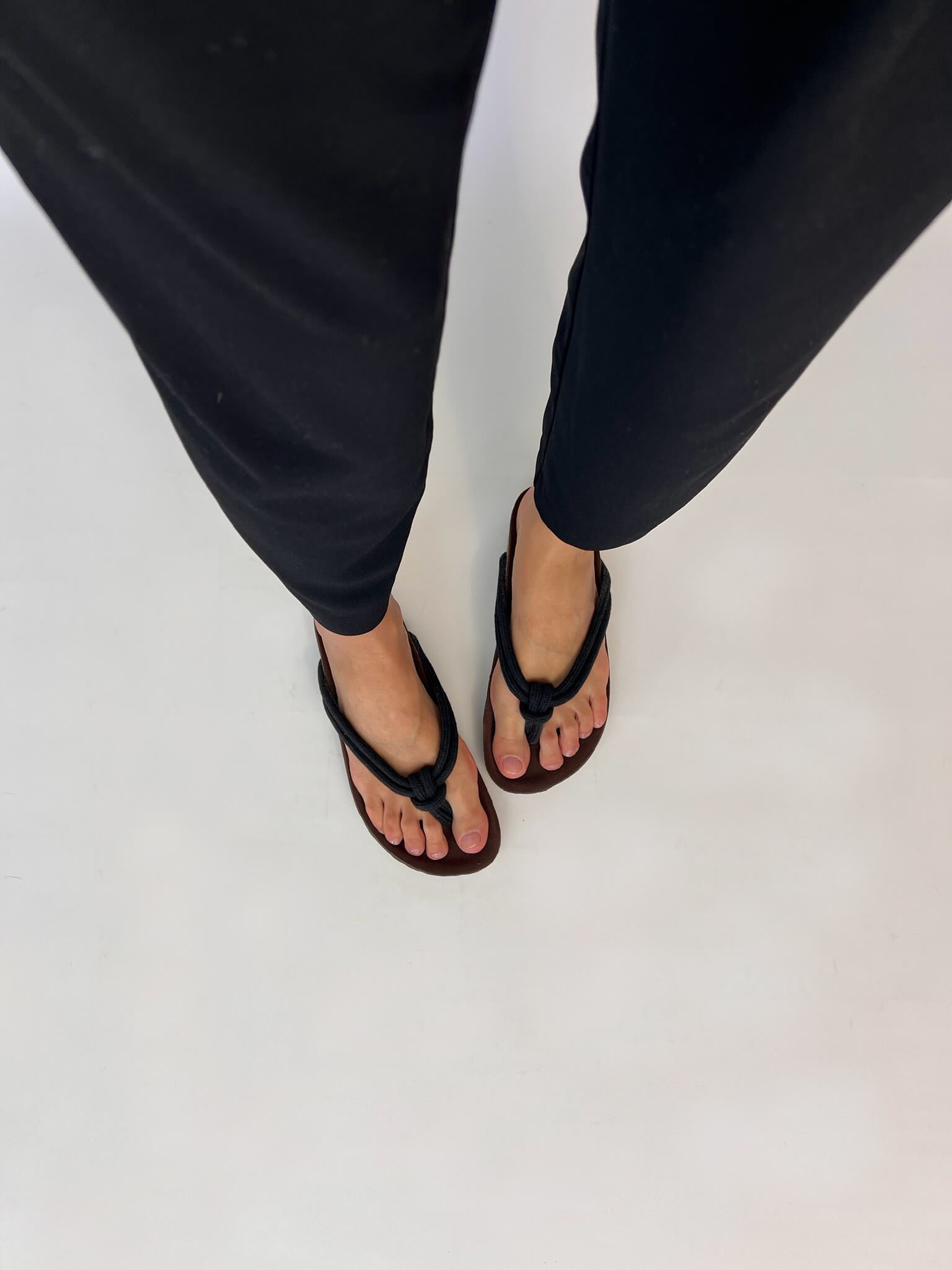 Momoc Javea black rope sandal top view both feet black trousers zero waste Spain | Momoc Shoes