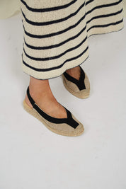Momoc Garachico black jute sandal worn side view striped skirt white background | Momoc Shoes