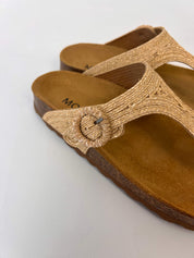 Momoc Altea natural raffia sandal close up hand adjusting raffia buckle detail Spain | Momoc Shoes Spain