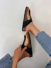 Momoc Altea black raffia sandal held by hand side view raffia buckle cork sole | Momoc Shoes