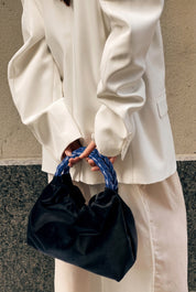 Momoc Montmartre black velvet bag cobalt blue handle held by hand white outfit | Momoc Shoes